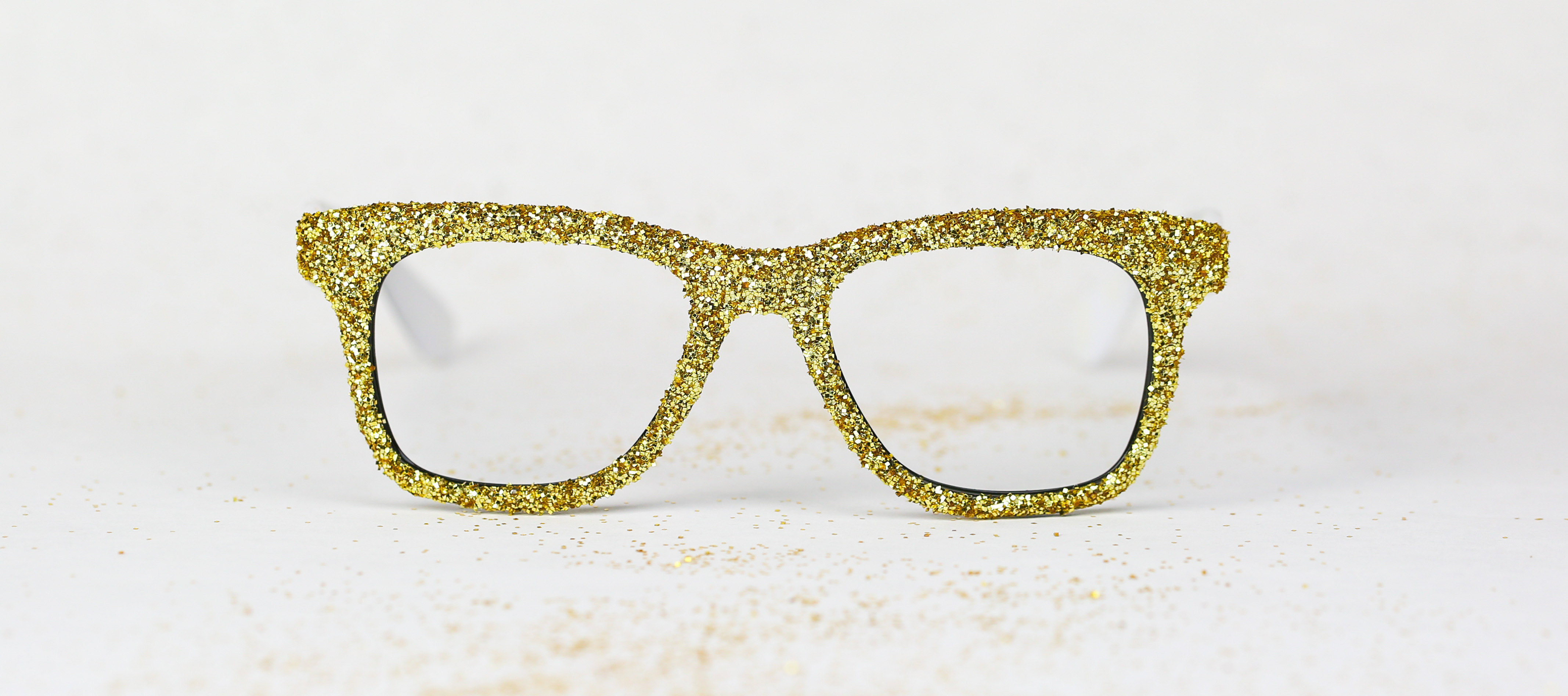 Gold glitter-covered eyeglass frames.