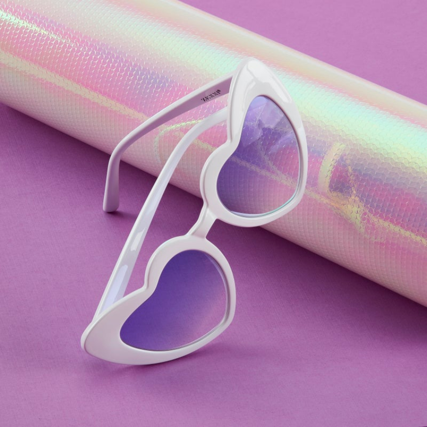 Heart-shaped white sunglasses with purple lenses. Brand name "ZACASS" is visible on the inside of the arm.