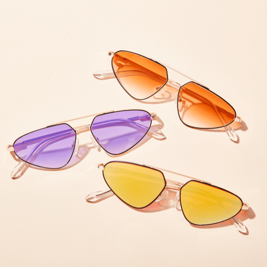 Three pairs of aviator sunglasses with colored lenses: orange, purple, and yellow.