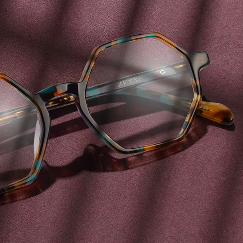 Tortoiseshell hexagonal glasses with thin lenses, "ZENNI" engraved on the inside of the temple.