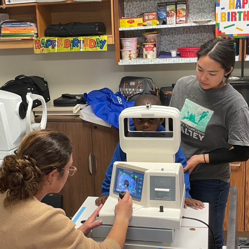 Child using a WR-500K Auto Ref-Keratometer for an eye examination.