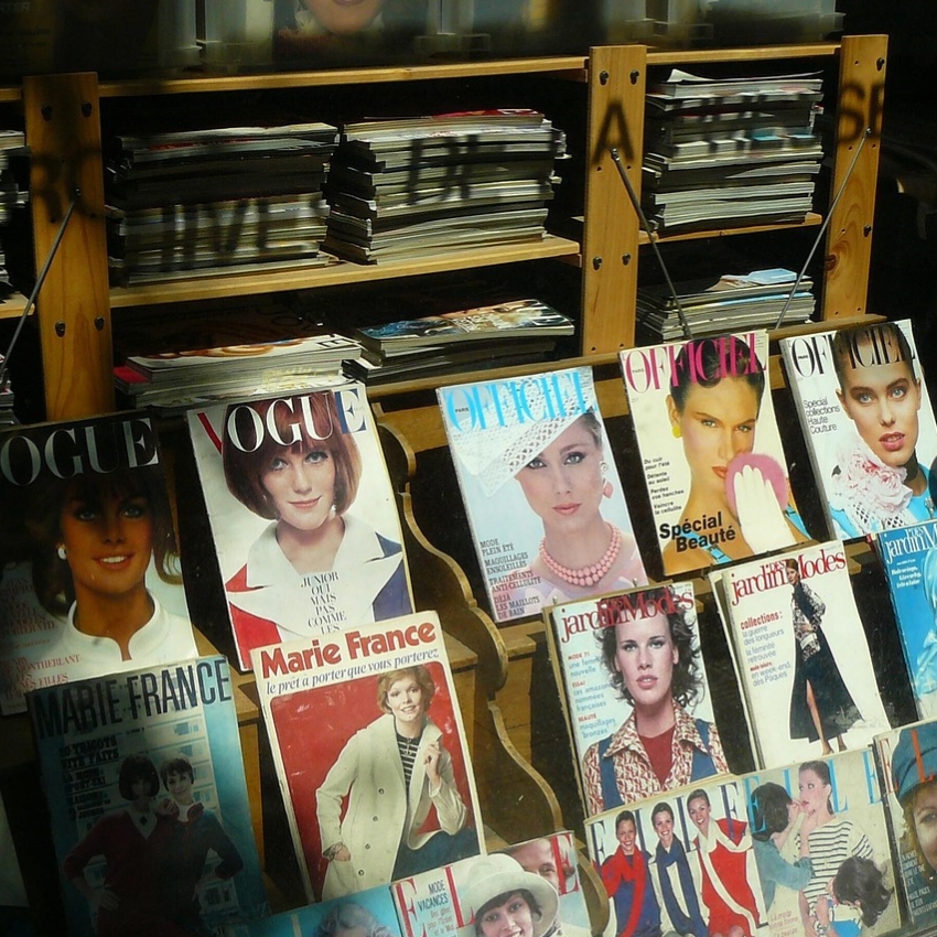 Magazines on display including Vogue, L'Officiel, Marie France, and Jardin Des Modes with various cover models.